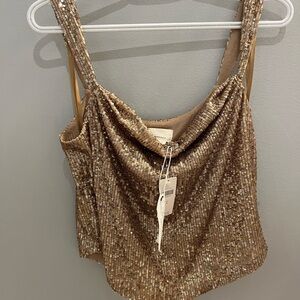 Anthropologie size small sequenced top. Never worn.